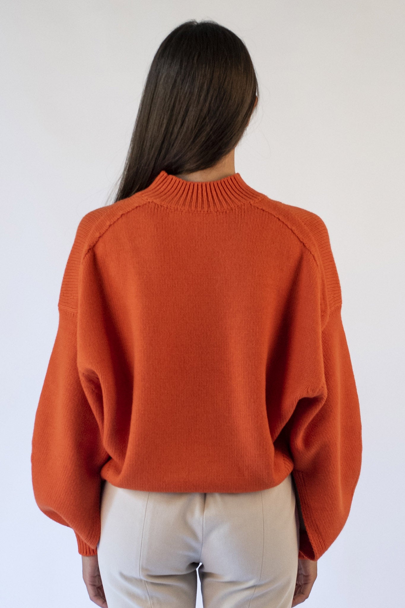 Orange turtleneck sweater with Isabella jewel buttons